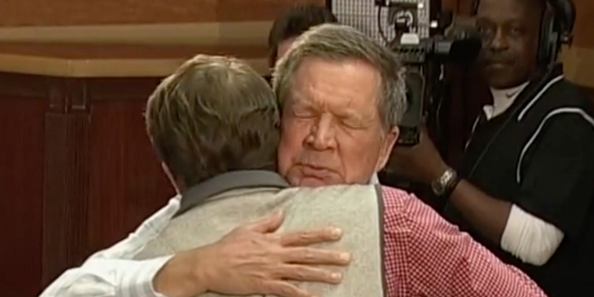 John Kasich hugging a supporter.