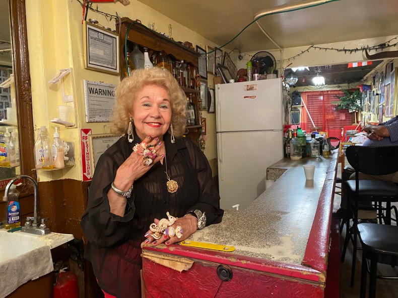 Maria Antonia Cay, better known as Toita, shows off her bedazzled rings behind the bar where she serves beer to her clients.Barbara Corbellini Duarte / Business Insider