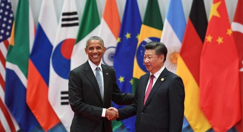 China's President Xi Jinping (R) shakes hands with US President Barack Obama before the G20 leaders' family photo in Hangzhou on September 4, 2016