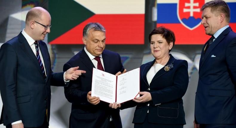 (L-R) Prime ministers of the Czech Republic (Bohuslav Sobotka), Hungary (Viktor Orban), Poland (Beata Szydlo) and Slovakia (Robert Fico) display the signed Warsaw declaration after a meeting on March 28, 2017