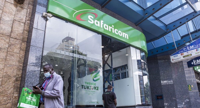 A customer wearing a protective face mask exits a Safaricom Plc store in central Nairobi, Kenya, on Tuesday, May 11, 2021. (Photographer: Patrick Meinhardt/Bloomberg via Getty Images)