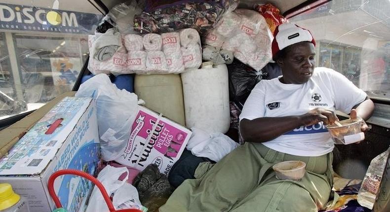 A  Zimbabwean woman  sits in the back of a truck loaded with groceries she purchased in Messina, South Africa, April 14, 2008.   REUTERS/Philimon Bulawayo