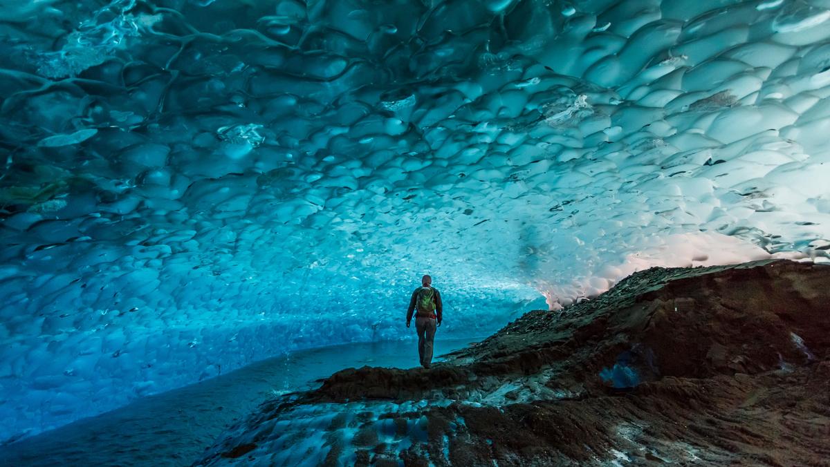 Man in glacier cave, Mendenhall Glacier, Juneau, Alaska