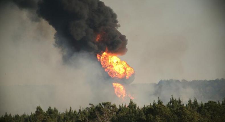 Flames shoot into the sky from a gas line explosion in western Shelby County, Alabama.  