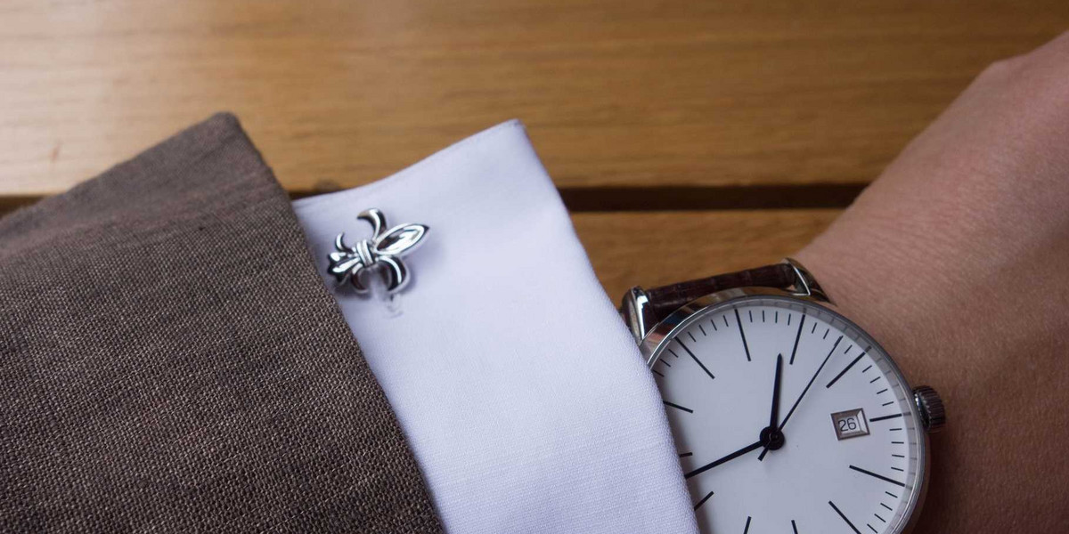 A minimalist Kent Wang watch with simple fleur-de-lis cuff links.