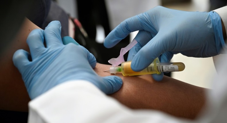 A technician extracts blood from a patient for an HIV test at the specialized Condesa Clinic in Mexico City on July 18, 2019, three days before the opening in the city of an international conference on HIV science