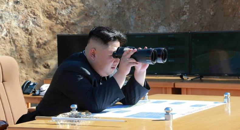 This picture taken and released by North Korea's official Korean Central News Agency (KCNA) shows North Korean leader Kim Jong-Un inspecting the test-fire of intercontinental ballistic missile Hwasong-14 at an undisclosed location