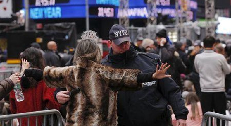 A woman is searched by a New York Police Department officer as she enters a pen to wait for the beginning.