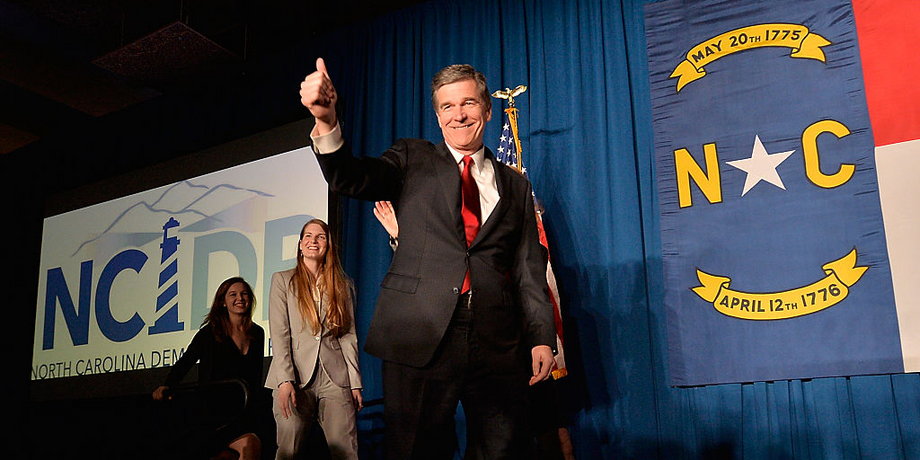 North Carolina Democratic presumptive Governor elect Roy Cooper waves to a crowd at the North Carolina Democratic Watch Party as he walks on stage with his family on November 9, 2016 in Raleigh, North Carolina.