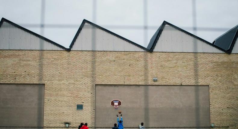 Refugees play basketball outside the Sundbyberg shelter, north-west of Stockholm, on October 13, 2015
