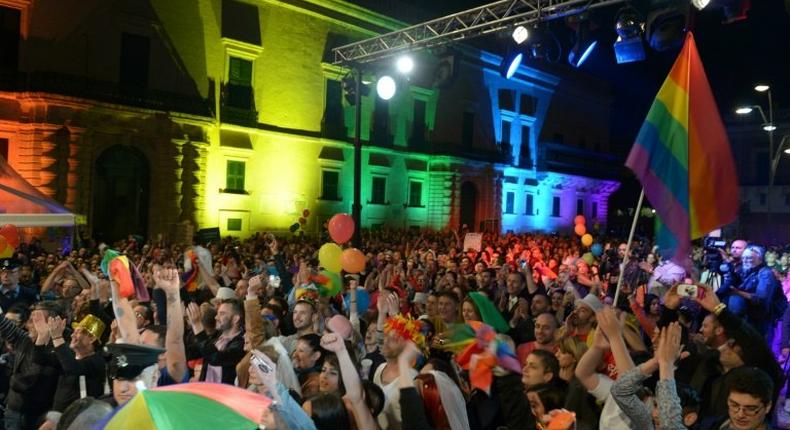 A file photo shows people celebrating the approval of a civil unions bill in the Maltese capital on April 14, 2014