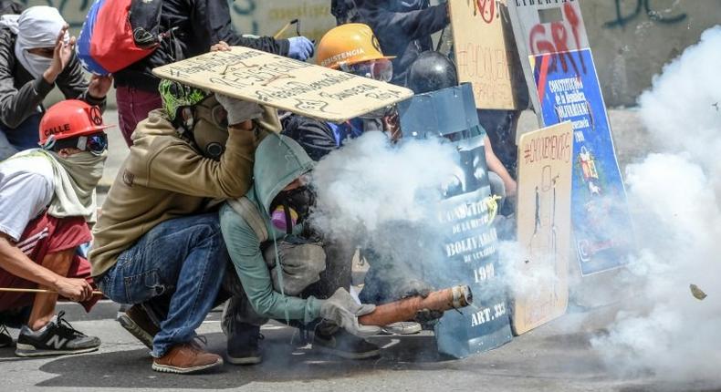 Opposition demonstrators clash with police during a protest in Caracas