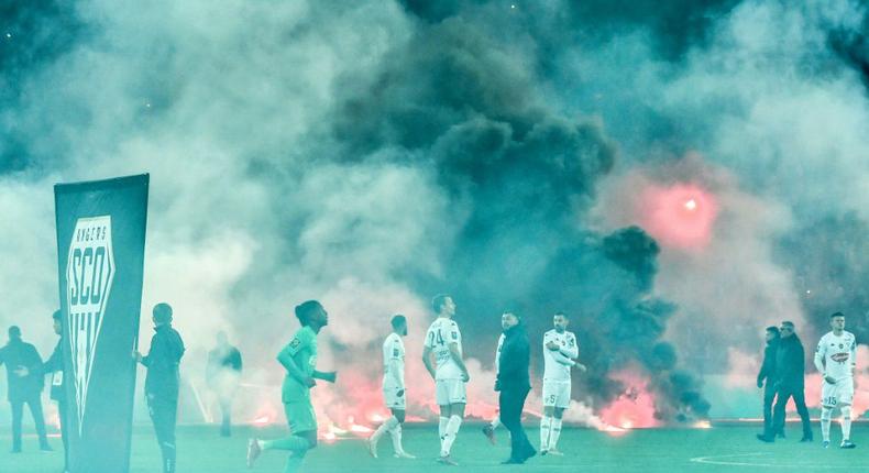 Under fire:Saint-Etienne and Angers players swathed in smoke as kick off was delayed in their Ligue 1 game Creator: PHILIPPE DESMAZES
