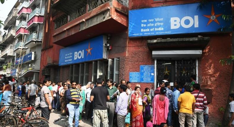 People queue outside a bank in Kolkata to deposit and exchange 500 and 1000 currency notes after the government's shock decision to withdraw them from circulation