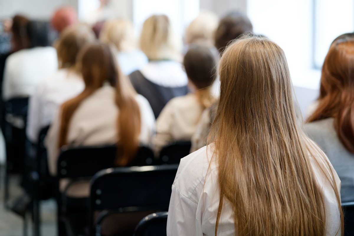 Back,View,Of,College,Or,University,Students,Sitting,On,Chairs