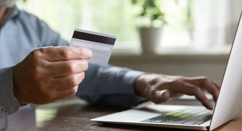 A stock image shows an older man making a payment online using his credit card.iStock/Getty Images