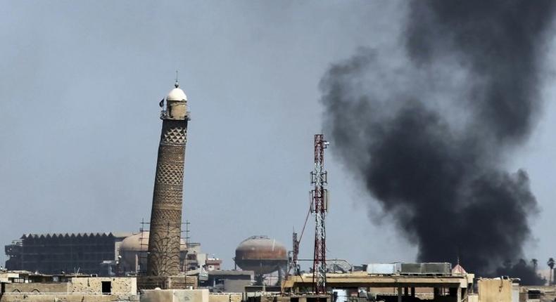 Smoke billows behind the emblemati Al-Nuri mosque in Mosul's Old City, where Iraqi forces have launched an assault on the Islamic State group