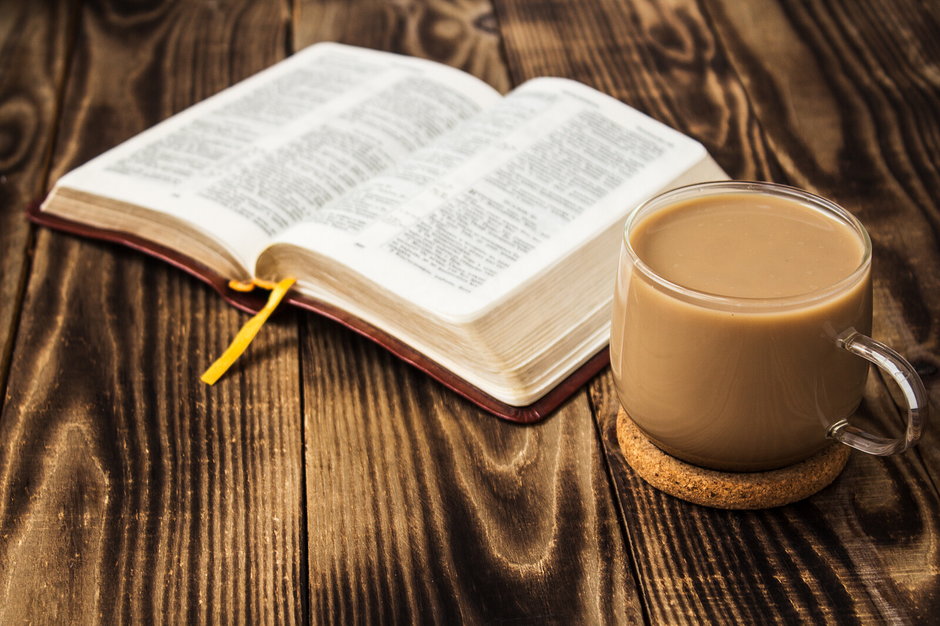 bible and coffee with milk on wooden background