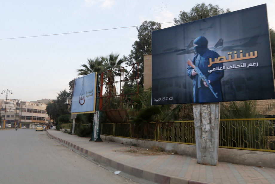 Islamic State billboards are seen along a street in Raqqa, eastern Syria, which is controlled by the Islamic State, October 29, 2014. The billboard reads: "We will win despite the global coalition".