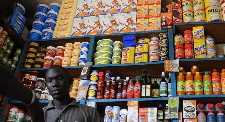 A shopkeeper receives payment in a roadside kiosk in Senegal's capital Dakar, file. REUTERS/Ricci Shryock/Files