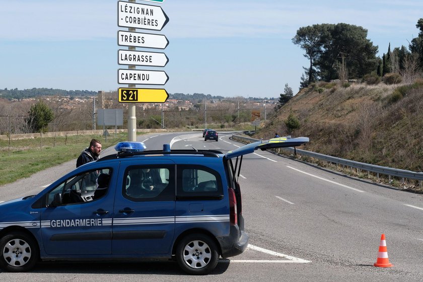 Police are seen at the scene of a hostage situation in a supermarket in Trebes