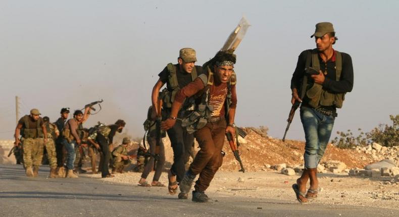 Free Syrian Army fighters battle Islamic State jihadists in Yahmoul in the Marj Dabiq area on October 10, 2016