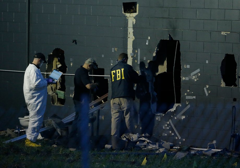 Police forensic investigators work at the crime scene of a mass shooting at the Pulse gay night club in Orlando, Florida, U.S. June 12, 2016.