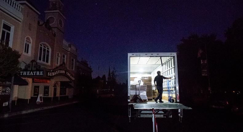 Armando Espinoza delivers paper products to a cafe in downtown Sonoma, Calif., where power is turned off, on Wednesday, Oct. 9, 2019.