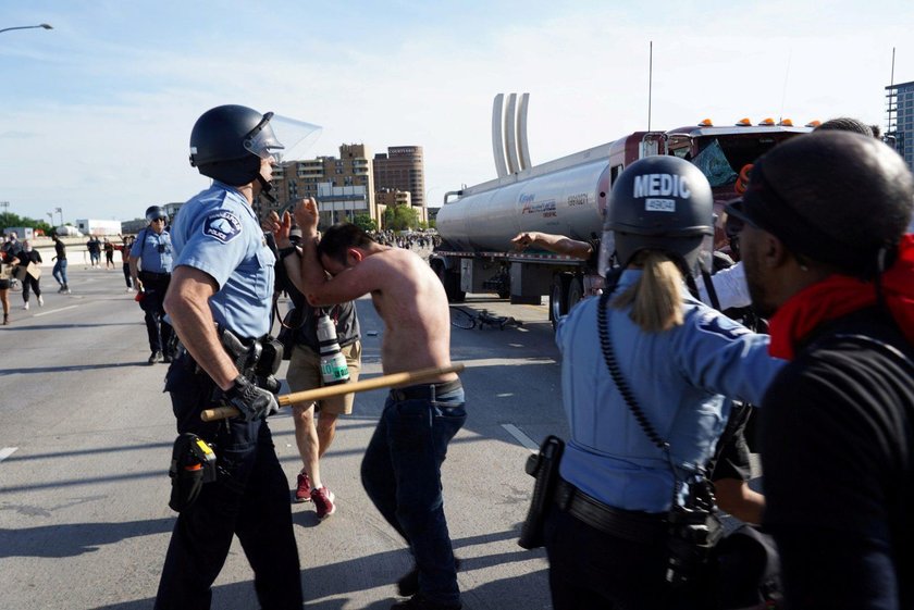 Protesters scale a truck that was driven into a rally