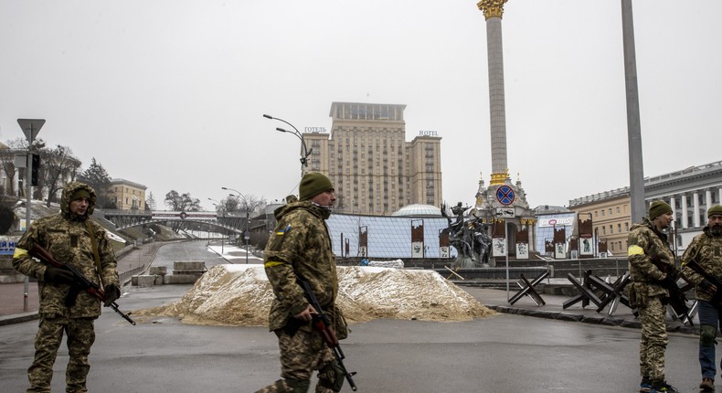 Soldiers are seen around piles of sand used for blocking a road in Kyiv, Ukraine, amid Russian attacks on March 2, 2022.