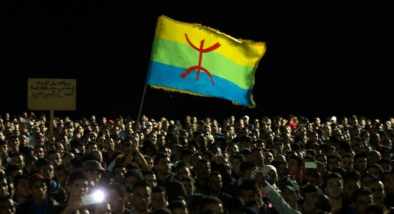 Protesters hold the Amazigh (Berber) flag during a demonstration in the northern Moroccan city of Al-Hoceima on October 30, 2016, following the death of fish seller Mouhcine Fikri