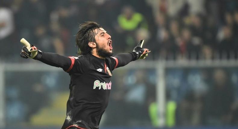 Genoa's goalkeeper from Italy Mattia Perin celebrates after teammate Leonardo Pavoletti scored during the Italian Serie A football match Genoa vs AC Milan at Luigi Ferraris Stadium in Genova on October 25, 2016