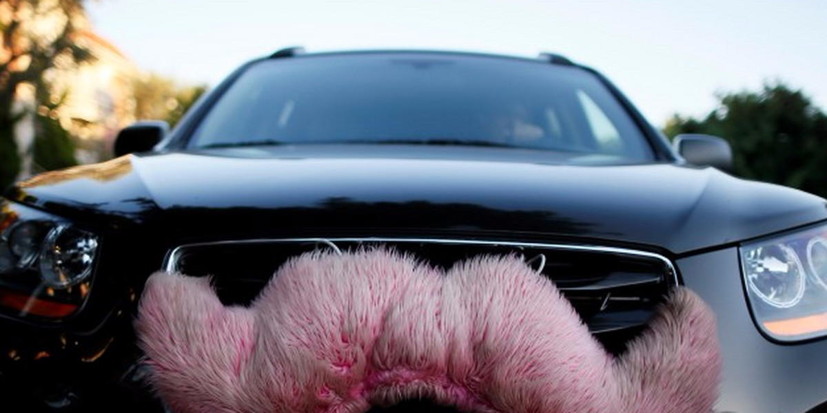 A driver with the ride-sharing service Lyft waits for a customer on a street in Santa Monica, California