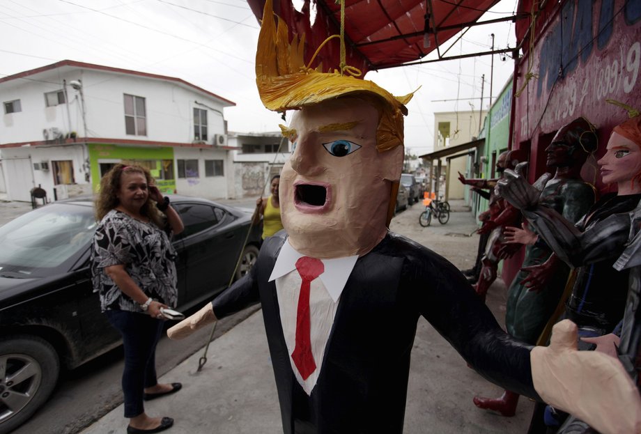 A Mexican client who lives in the US looks at a piñata depicting US Republican presidential candidate Donald Trump hanging outside a workshop in Reynosa, Mexico, June 23, 2015.