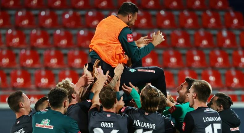 BClaudio Pizarro, 41, is cheered by his Werder Bremen team-mates as he retired after their relegation/promotion play-off on Monday at Heidenheim.