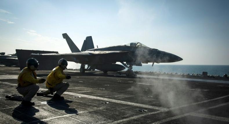 A F/A-18E Super Hornet launches from the flight deck of the Nimitz-class aircraft carrier USS Carl Vinson