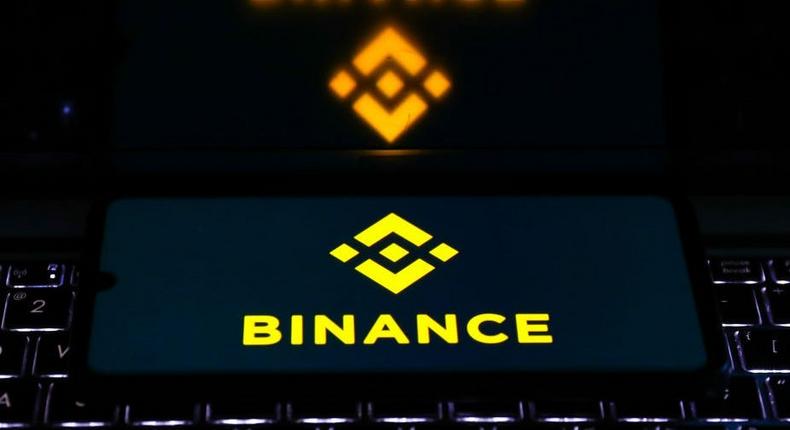 Binance logo is displayed on a mobile phone screen