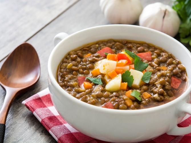 stock-photo-lentil-soup-in-a-bowl-on-wooden-background-576176569