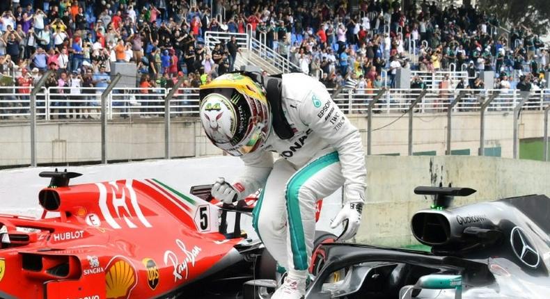 Lewis Hamilton celebrates after taking pole position