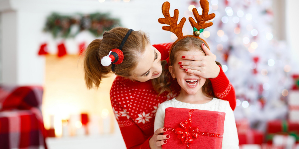 happy family mother and daughter giving christmas gift 