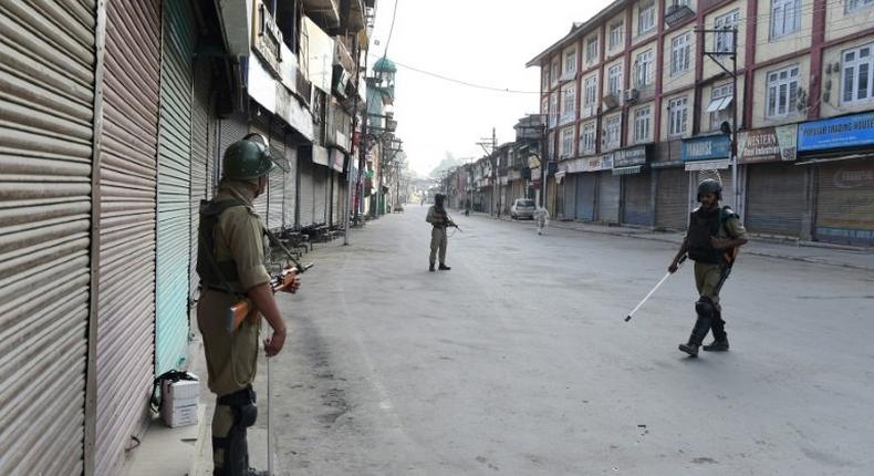 Paramilitary troops patrol the deserted streets of Srinagar as Indian Kashmir marks the first anniversary of a hugely popular rebel leader's death