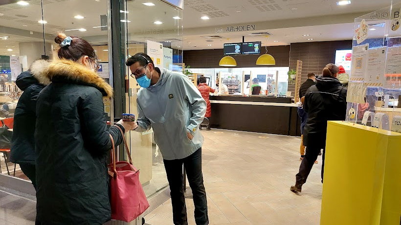 Kontrola paszportów covidowych przed wejściem do McDonald's w Berlinie, 27.11.2021 r.