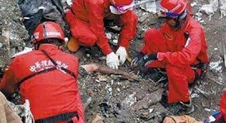 Rescue workers discover dead couple with arms wrapped around each other under rubble