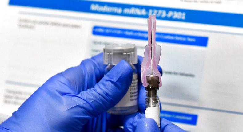 A nurse prepares a shot of Moderna's COVID-19 vaccine.
