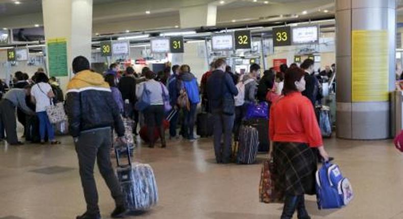 Passengers stand in a line to get registered for the flight ZF 9785 of Azur Air from Domodedovo airport to Sharm al-Sheikh outside Moscow, Russia, November 6, 2015.