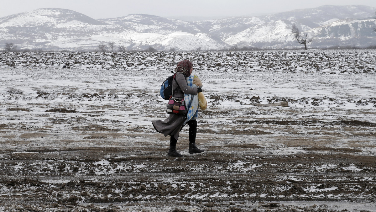 A migrant walks through a frozen field after crossing the border from Macedonia, near the village of Miratovac, Serbia
