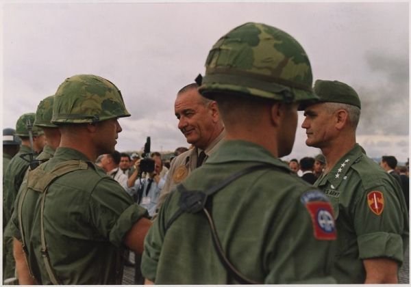 Prezydent USA Lyndon B. Johnson na spotkaniu z żołnierzami w Wietnamie. Obok gen. William Westmoreland (26 października 1966, domena publiczna).