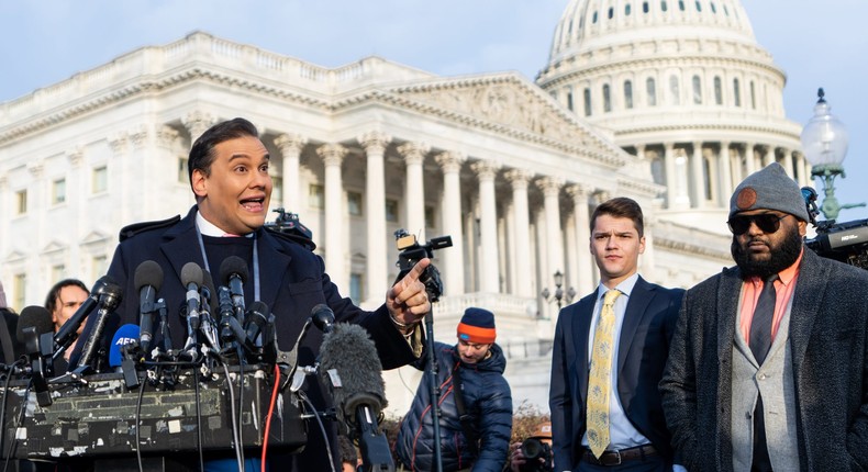 Two of Santos's congressional staffers look on as he speaks at a press conference on Thursday.Bill Clark/CQ-Roll Call via Getty Images