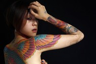 Nai, whose husband is a tattoo artist, poses for a portrait with Reuters during the 2010 Taiwan International Tattoo Convention in Taipei