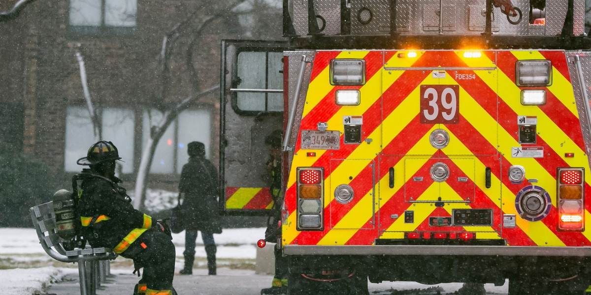 Fire fighters work to contain a deadly apartment building blaze in Chicago